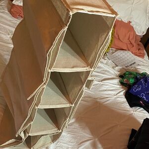 Collapsible hanging shoe/closet organizer. Has side areas for extra storage